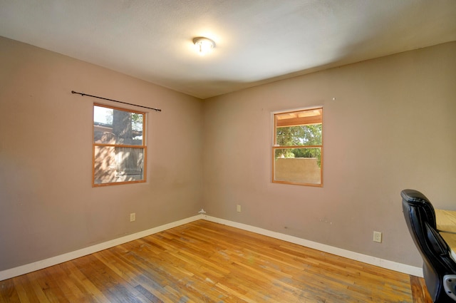 unfurnished office featuring light hardwood / wood-style floors