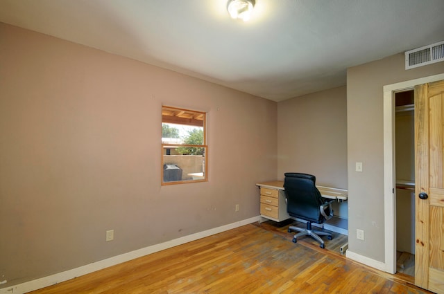 unfurnished office featuring light wood-type flooring