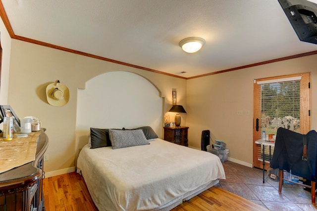 bedroom featuring crown molding and hardwood / wood-style floors