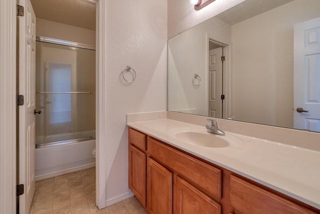 full bathroom with vanity, combined bath / shower with glass door, and toilet