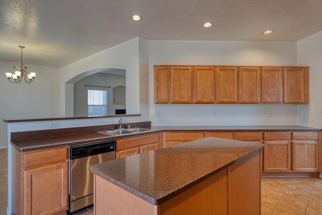 kitchen with sink, a textured ceiling, stainless steel dishwasher, a kitchen island, and a notable chandelier