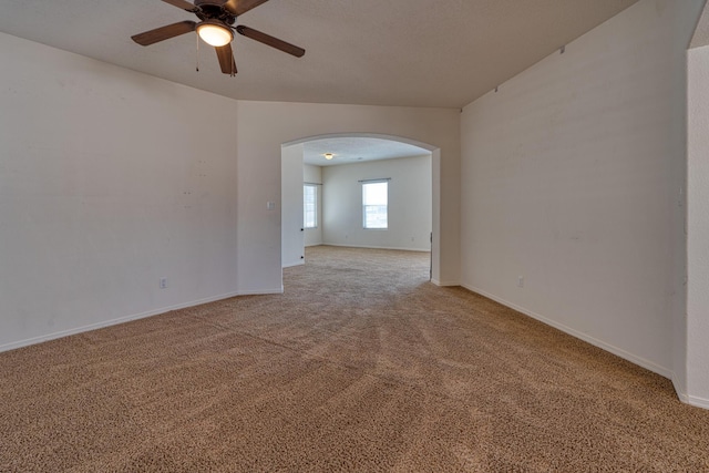 carpeted spare room featuring ceiling fan