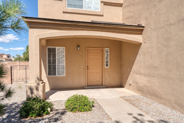 view of exterior entry with a patio