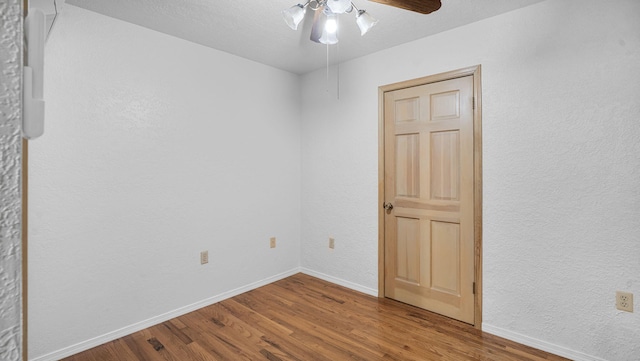 empty room with ceiling fan and wood-type flooring