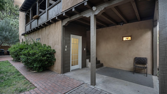 view of exterior entry featuring a patio area