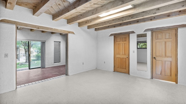 spare room with beam ceiling and wooden ceiling