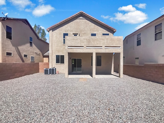 back of house with a patio, a balcony, and central air condition unit