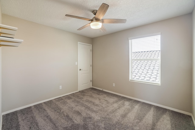 empty room with carpet floors, a textured ceiling, and ceiling fan