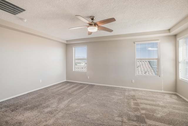 unfurnished room with ceiling fan, carpet flooring, and a textured ceiling