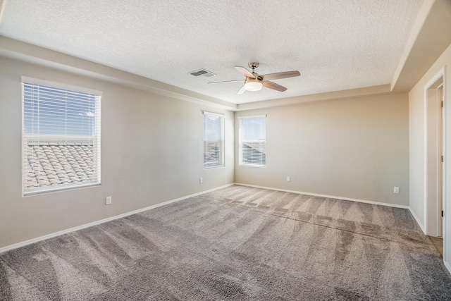 carpeted empty room featuring ceiling fan and a textured ceiling