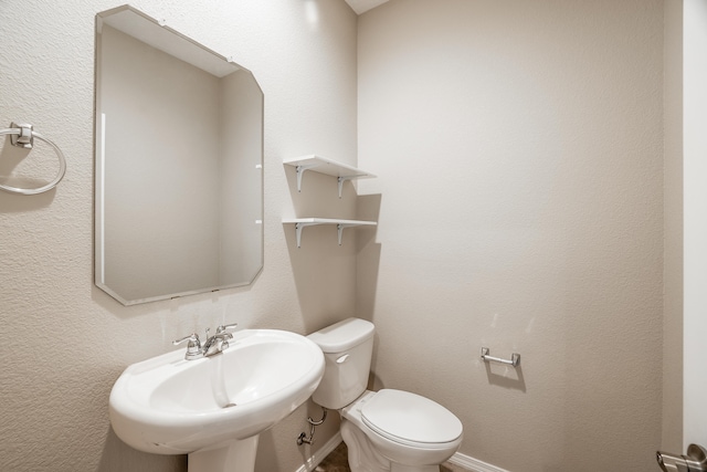 bathroom with sink and toilet