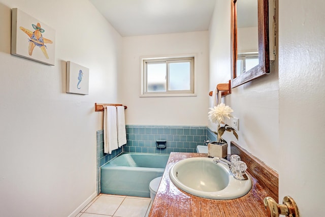 bathroom featuring vanity, tile patterned floors, and a bathing tub