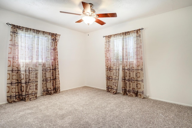 carpeted empty room featuring ceiling fan