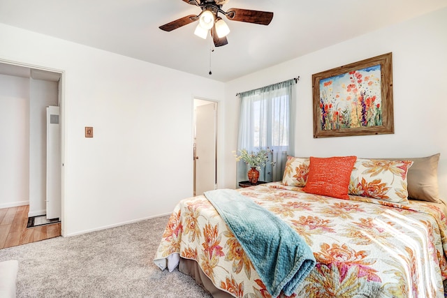 bedroom with ceiling fan and light carpet