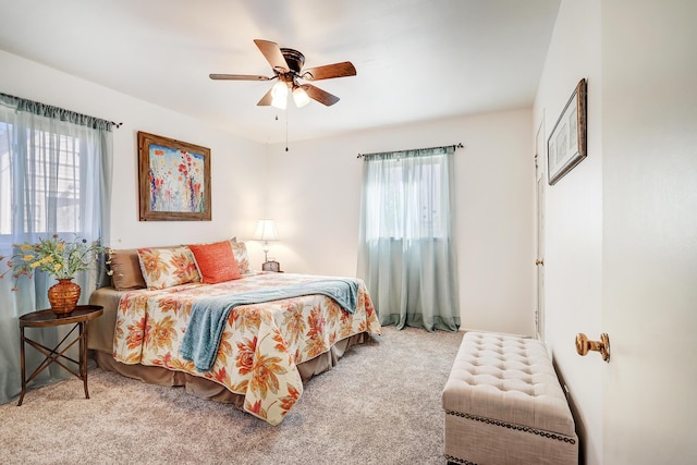 bedroom with ceiling fan, carpet flooring, and multiple windows