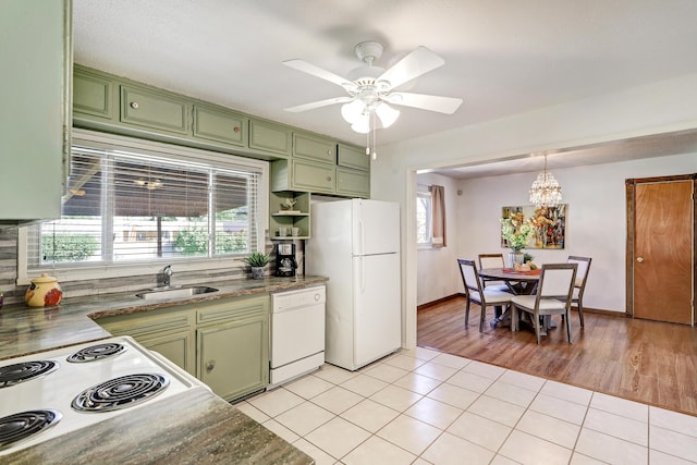 kitchen with sink, white appliances, green cabinetry, and light tile patterned flooring