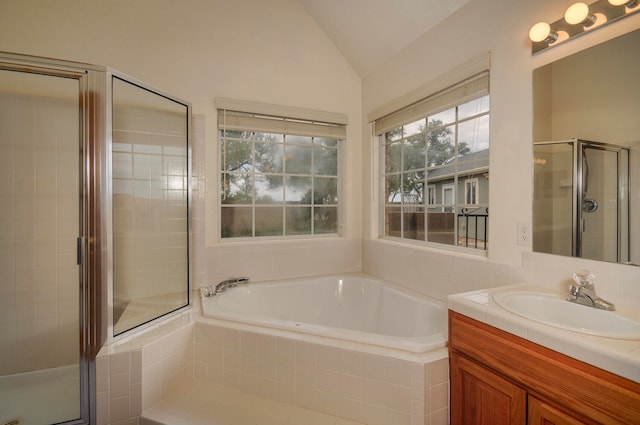 bathroom with vanity, lofted ceiling, and plus walk in shower