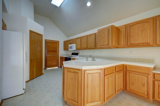 kitchen with kitchen peninsula, high vaulted ceiling, tile counters, sink, and white appliances