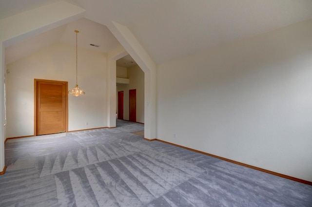 interior space with carpet and vaulted ceiling