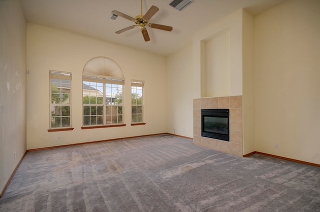 unfurnished living room with ceiling fan, high vaulted ceiling, carpet, and a fireplace