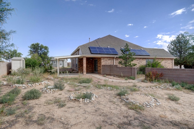 back of house with solar panels