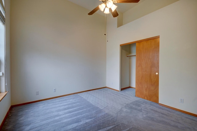 unfurnished bedroom featuring light colored carpet, a closet, and ceiling fan