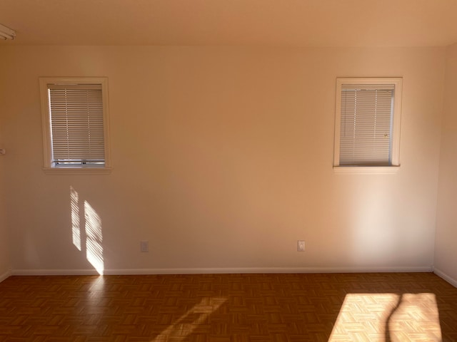 unfurnished room featuring dark parquet flooring