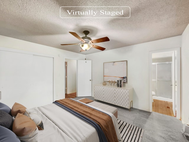 bedroom featuring connected bathroom, ceiling fan, carpet floors, and a textured ceiling