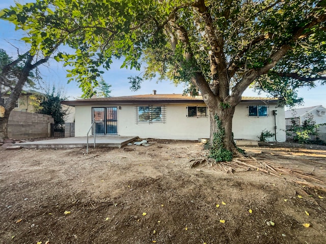 back of property with a patio