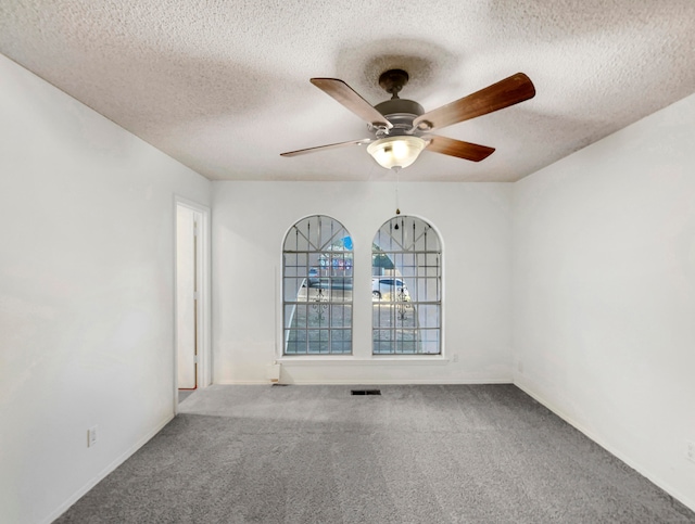 unfurnished room featuring carpet flooring, a textured ceiling, and ceiling fan