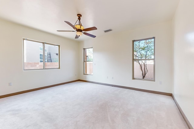 carpeted spare room with ceiling fan