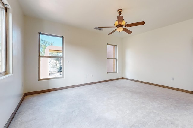 carpeted empty room featuring ceiling fan