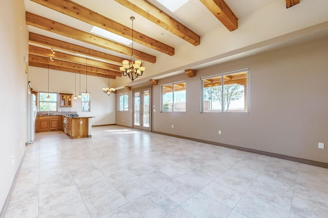 unfurnished living room featuring beamed ceiling and an inviting chandelier