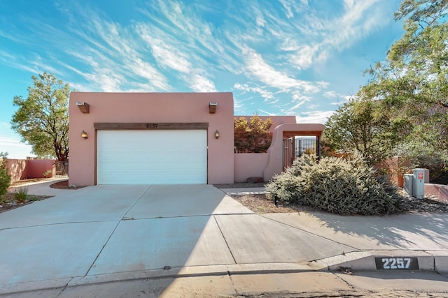 pueblo-style home featuring a garage