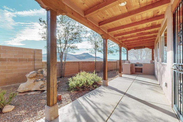 view of patio / terrace with an outdoor kitchen and a mountain view