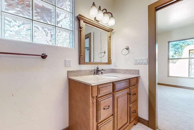 bathroom with plenty of natural light and vanity