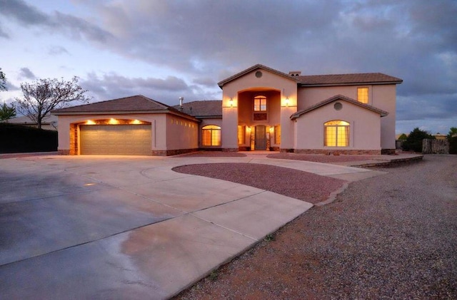 mediterranean / spanish-style house featuring a garage