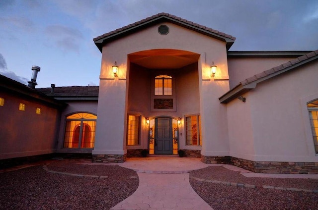 view of exterior entry at dusk