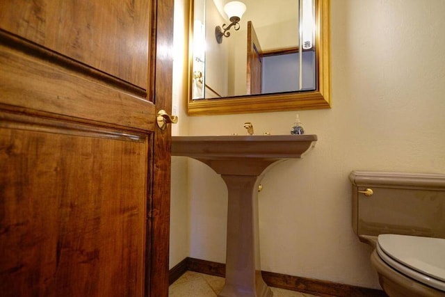 bathroom featuring tile patterned floors and toilet