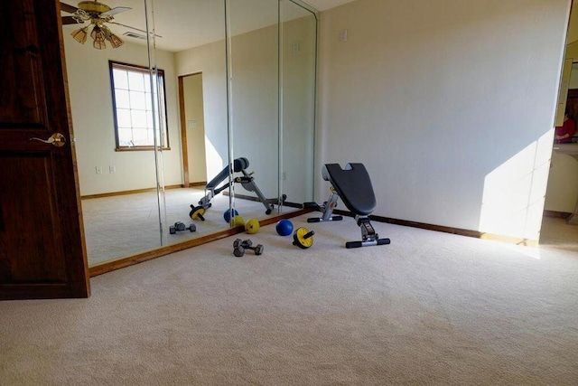 workout area featuring light colored carpet and ceiling fan