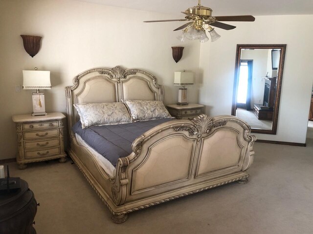 bedroom featuring dark colored carpet and ceiling fan