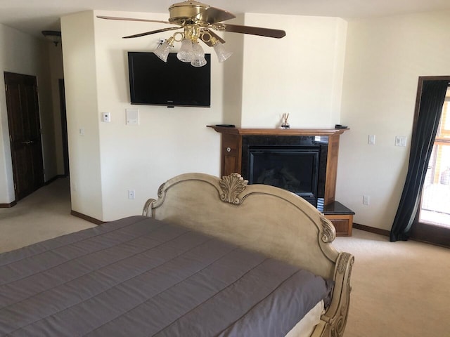 280 Angel Rd, Corrales, NM 87048 - bedroom featuring light colored carpet, a glass covered fireplace, and a ceiling fan