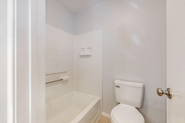 bathroom with toilet and a washtub