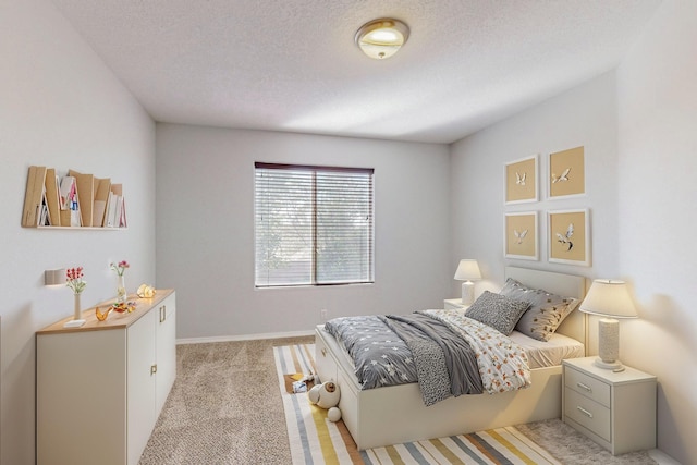 carpeted bedroom with a textured ceiling