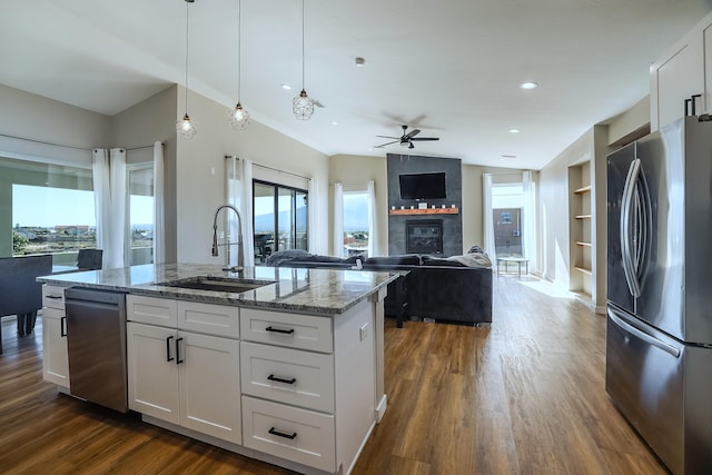 kitchen with a wealth of natural light, white cabinetry, and appliances with stainless steel finishes