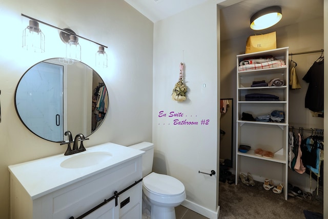 bathroom with walk in shower, vanity, toilet, and tile patterned floors