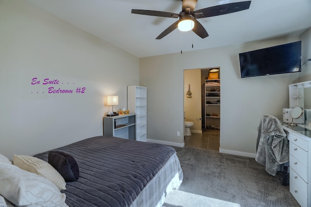 carpeted bedroom featuring ceiling fan, a closet, and a spacious closet