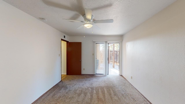 interior space featuring carpet, ceiling fan, and a textured ceiling