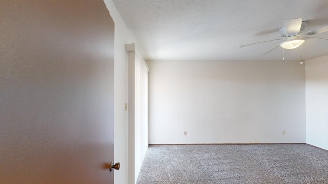 empty room featuring ceiling fan and carpet flooring