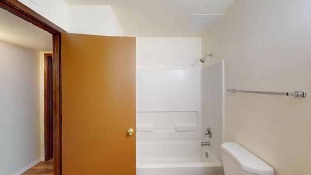 bathroom with shower / bathtub combination, toilet, and wood-type flooring